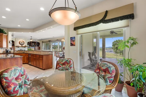 a very nice looking dining room with kitchen island furniture and a chandelier