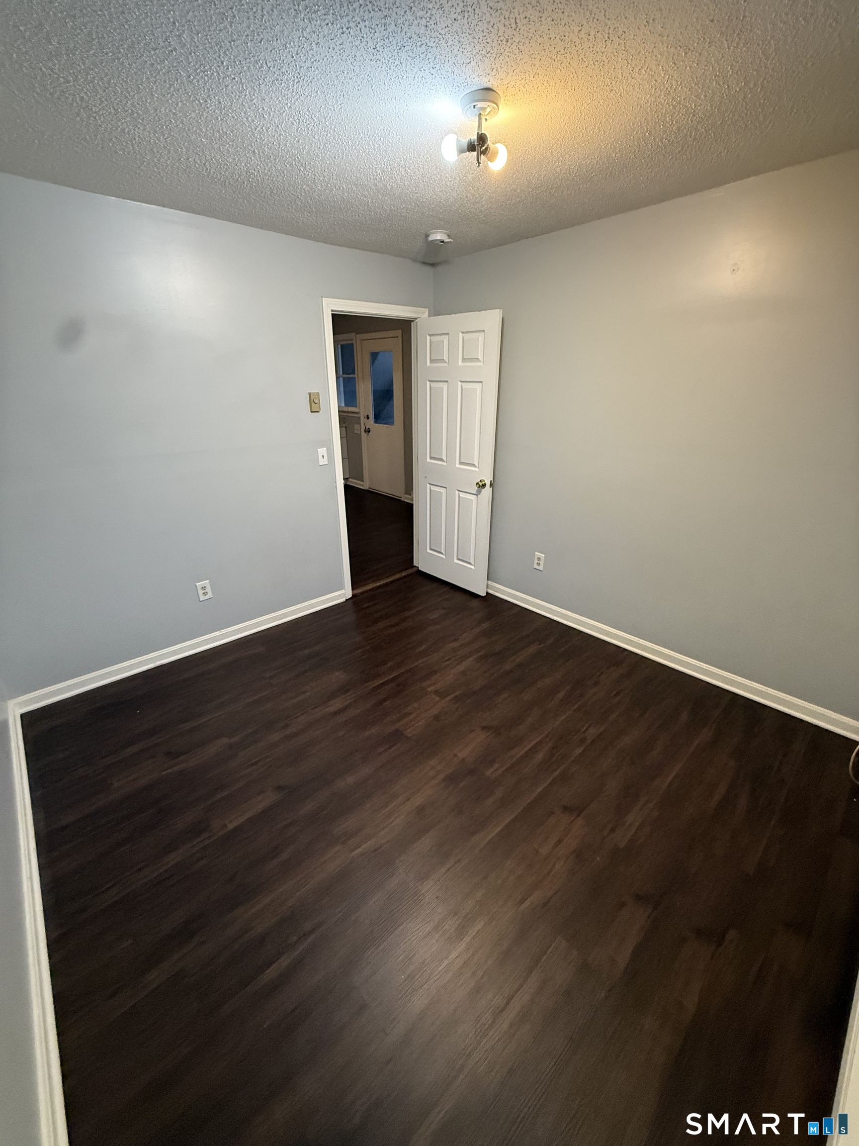52 Crown Street Naugatuck, CT 06770 - Photo 11 of 11 an empty room with wooden floor and windows