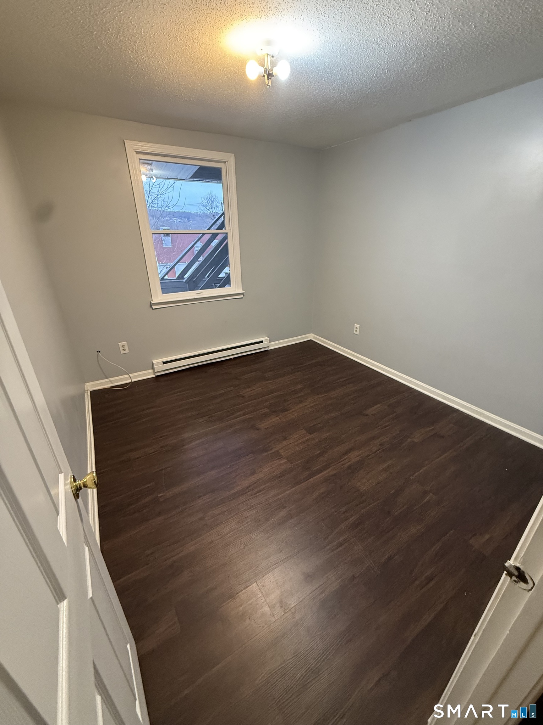 52 Crown Street Naugatuck, CT 06770 - Photo 3 of 11 an empty room with wooden floor