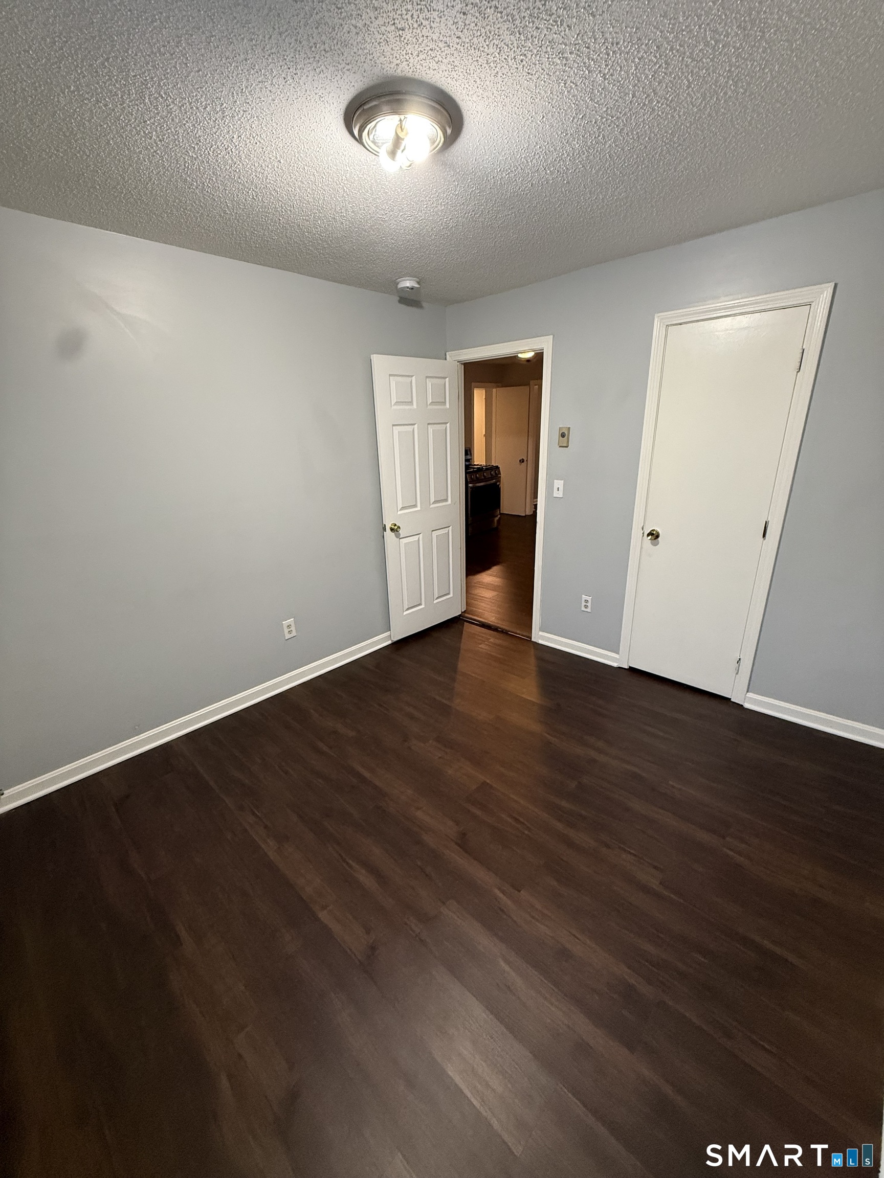 52 Crown Street Naugatuck, CT 06770 - Photo 4 of 11 an empty room with wooden floor and windows