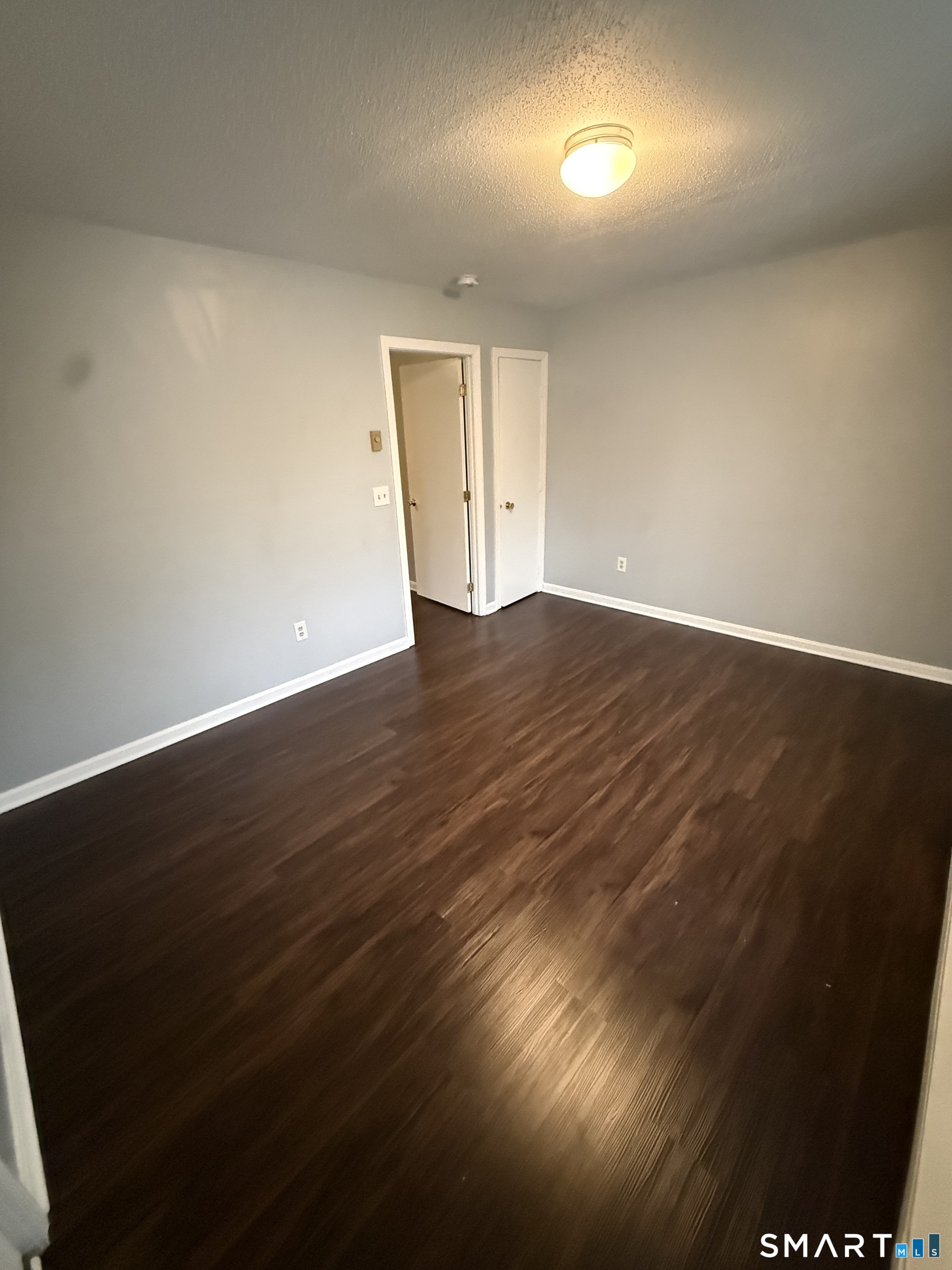 52 Crown Street Naugatuck, CT 06770 - Photo 6 of 11 an empty room with wooden floor and windows