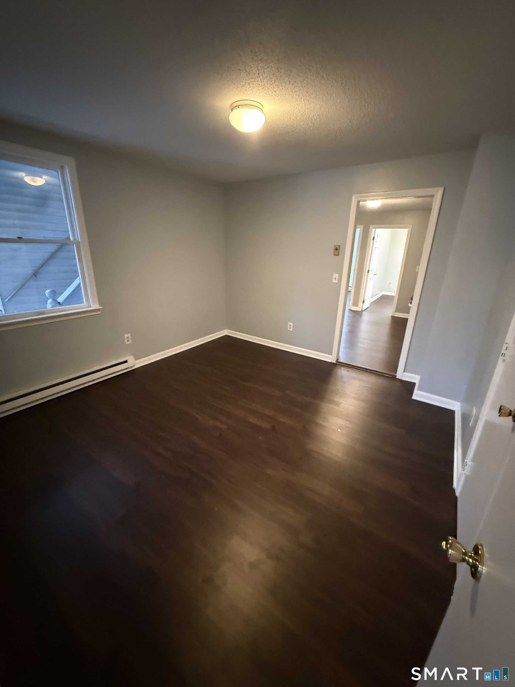 52 Crown Street Naugatuck, CT 06770 - Photo 7 of 11 an empty room with wooden floor and windows