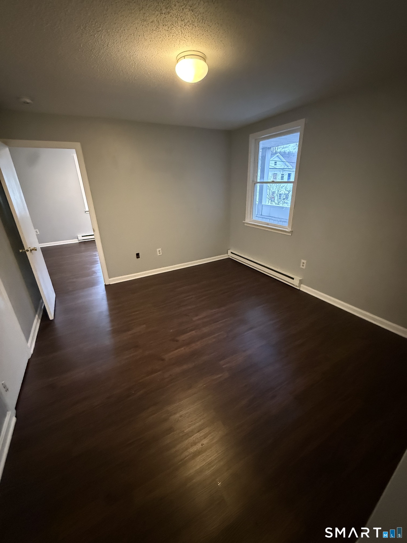 52 Crown Street Naugatuck, CT 06770 - Photo 9 of 11 a view of an empty room with wooden floor and a window
