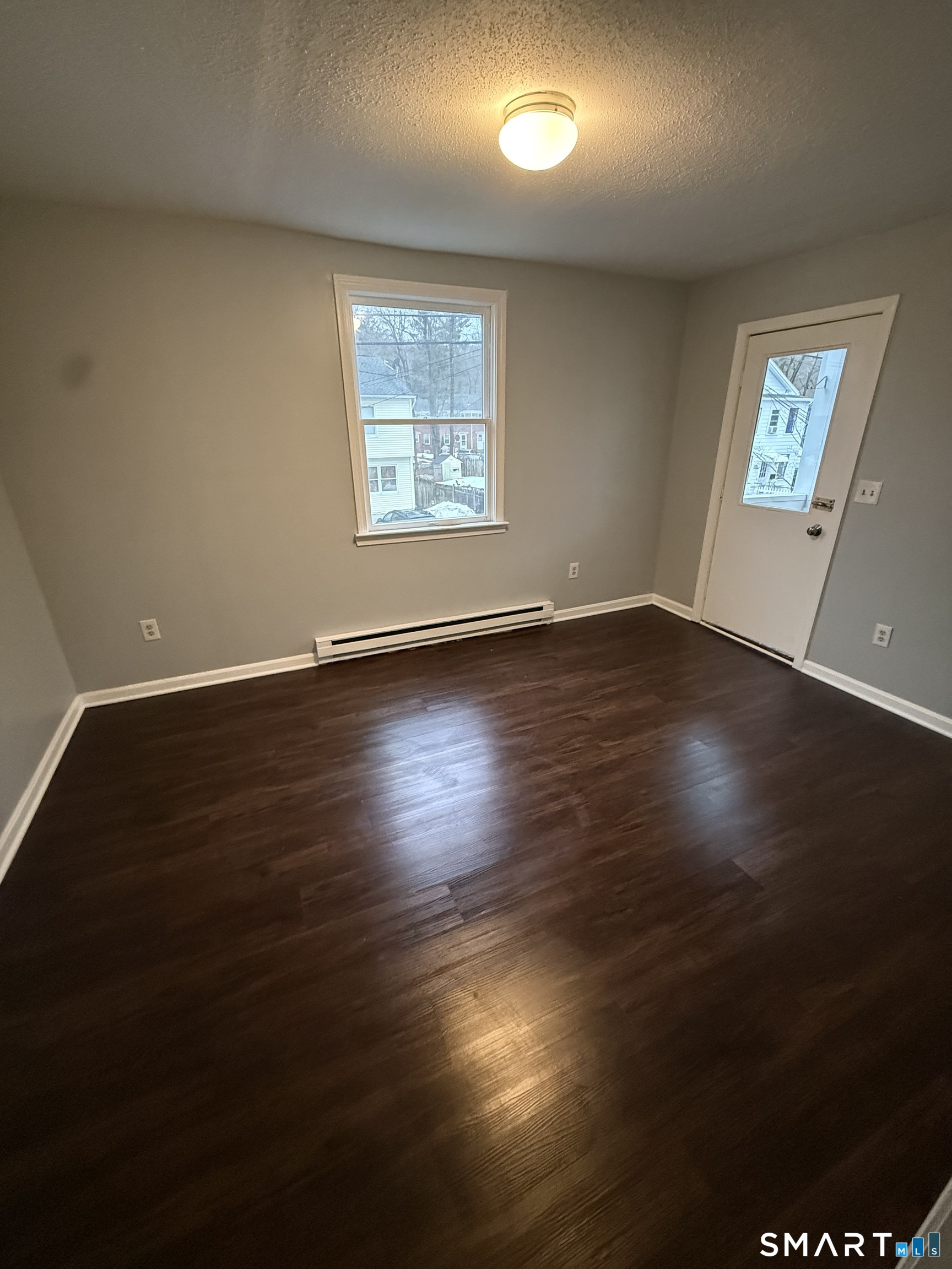 52 Crown Street Naugatuck, CT 06770 - Photo 10 of 11 an empty room with wooden floor and windows
