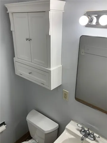 a white toilet sitting next to a bathroom sink