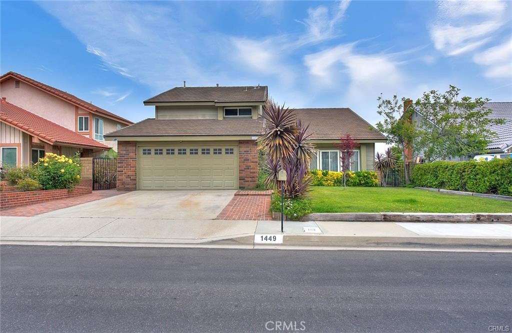 1449 Rolling Knoll Road Diamond Bar, CA 91765 - Photo 1 of 31 a front view of a house with a yard and a garage