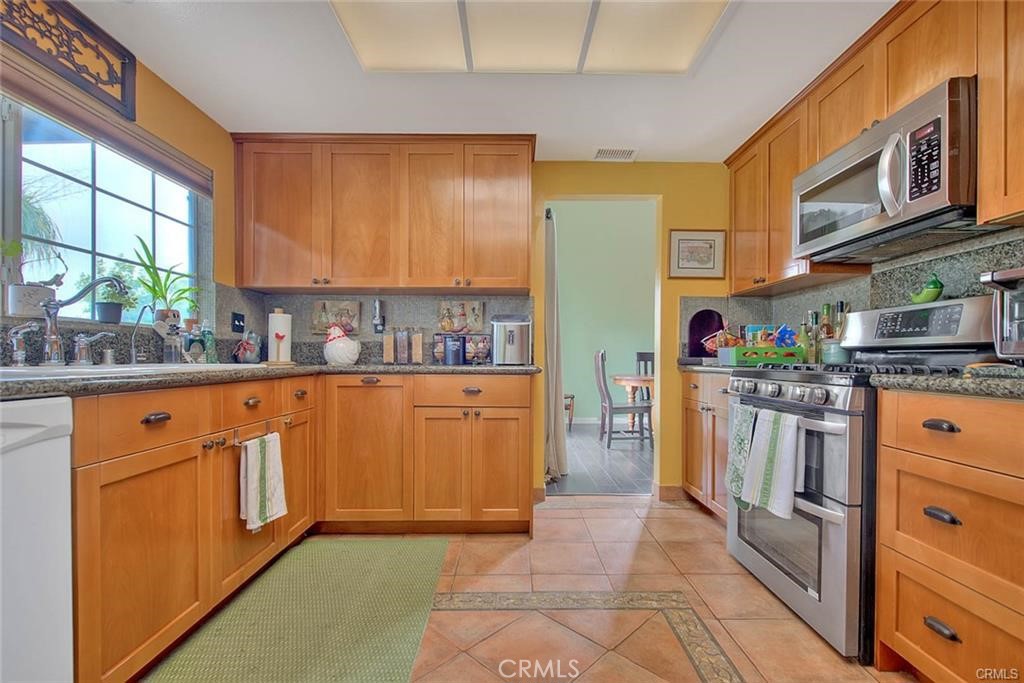 1449 Rolling Knoll Road Diamond Bar, CA 91765 - Photo 12 of 31 a kitchen with stainless steel appliances granite countertop a refrigerator and a stove top oven