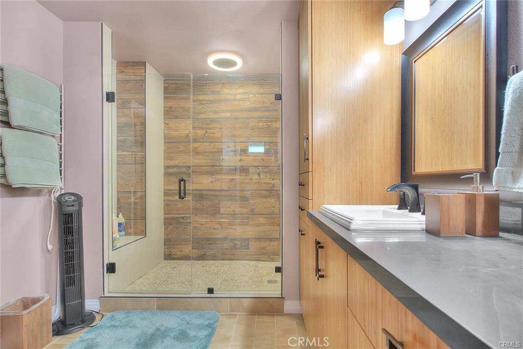 1449 Rolling Knoll Road Diamond Bar, CA 91765 - Photo 19 of 31 a bathroom with a granite countertop sink and a mirror
