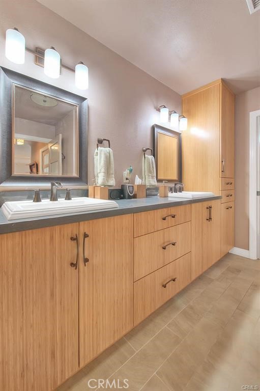 1449 Rolling Knoll Road Diamond Bar, CA 91765 - Photo 20 of 31 a bathroom with a granite countertop sink and a mirror