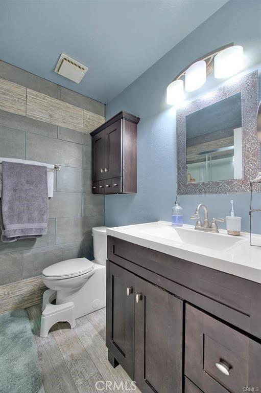 1449 Rolling Knoll Road Diamond Bar, CA 91765 - Photo 25 of 31 a bathroom with a granite countertop toilet sink and mirror