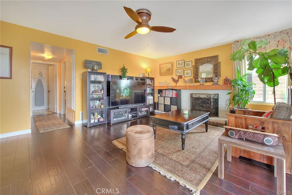 1449 Rolling Knoll Road Diamond Bar, CA 91765 - Photo 10 of 31 a living room with furniture a flat screen tv and a fireplace