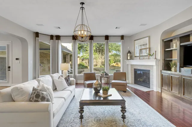 a living room with furniture a flat screen tv and a fireplace