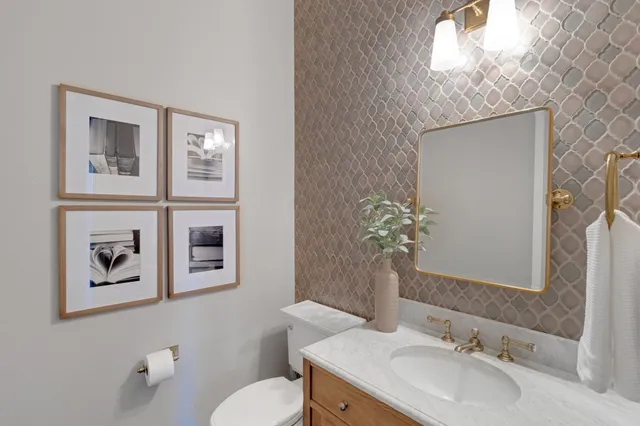 a spacious bathroom with a granite countertop sink and a mirror