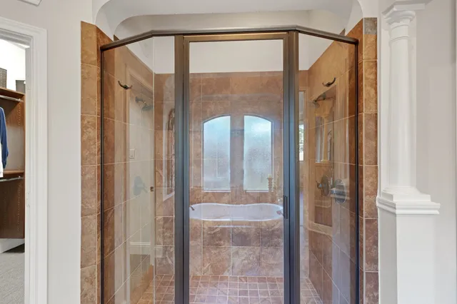 a bathroom with a granite countertop double vanity sink and a mirror