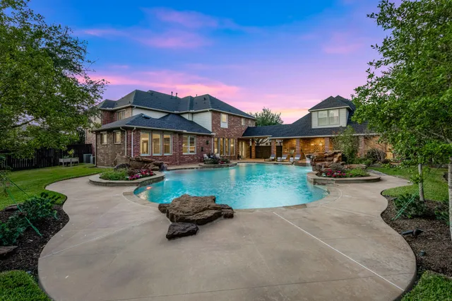 a view of patio with couches and table and chairs under an umbrella