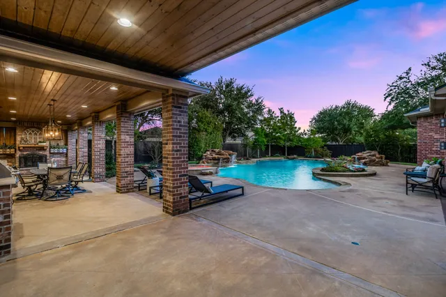 a view of swimming pool with outdoor seating and a patio