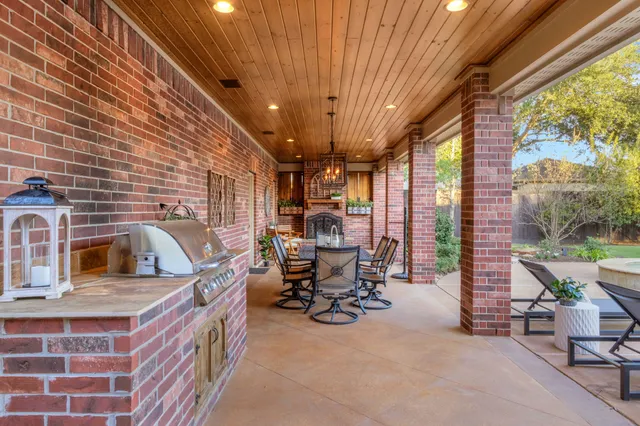a view of a patio with table and chairs