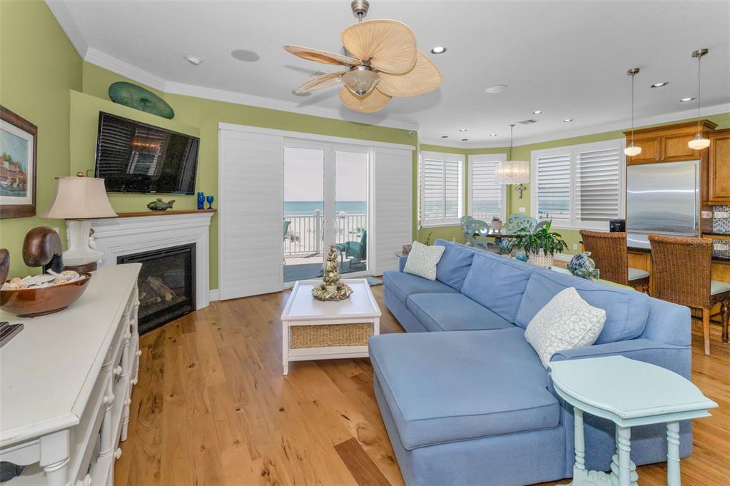 13303 Gulf Lane Madeira Beach, FL 33708 - Photo 10 of 42 a living room with fireplace furniture and a flat screen tv
