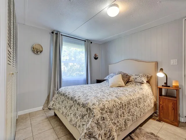 a bedroom with a bed and window