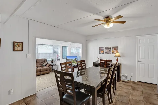 a view of a dining room with furniture and a chandelier