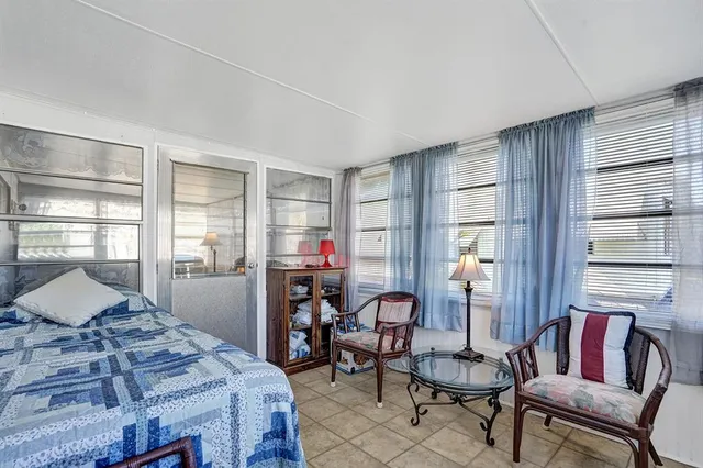 a bedroom with furniture and a window