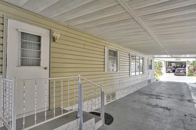 a view of a porch with a table and chairs
