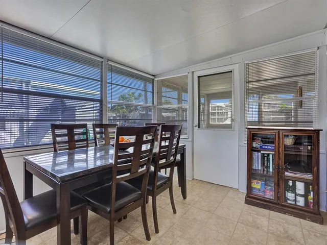 a dining room with a wooden table and chairs
