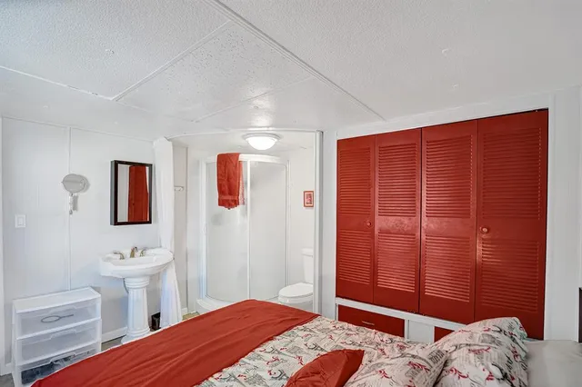 a bedroom with a bed and a sink