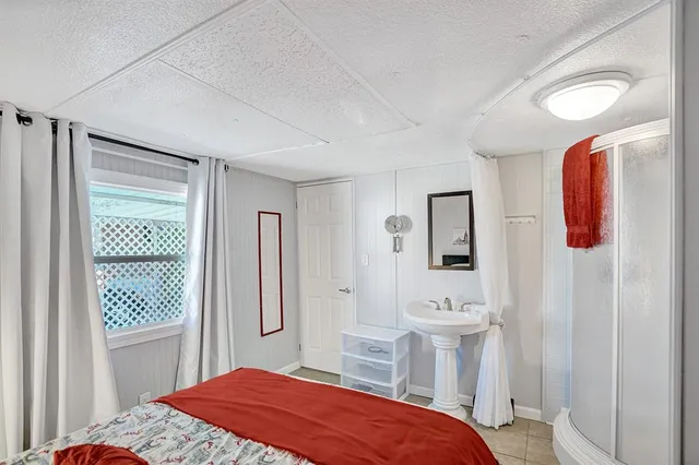 a bedroom with a bed and a mirror