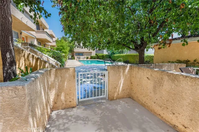 a view of a house with a wooden fence