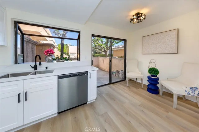 a kitchen with a sink and a potted plant