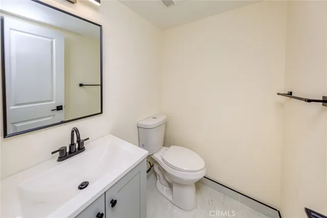 a bathroom with a sink a toilet and mirror