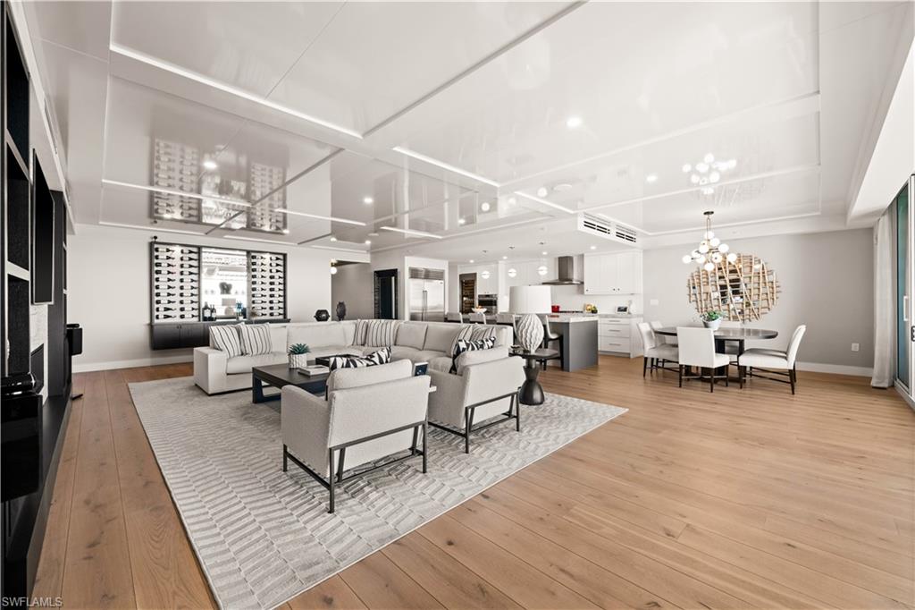 13925 Old Coast Road, Unit 1705 Naples, FL 34110 - Photo 11 of 42 Living room with light wood-style floors and a chandelier