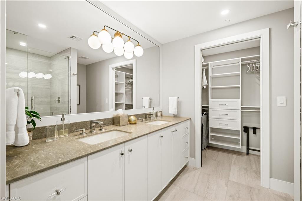 13925 Old Coast Road, Unit 1705 Naples, FL 34110 - Photo 22 of 42 Full bath with a walk in closet, double vanity, a stall shower, and recessed lighting