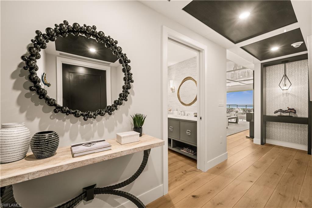 13925 Old Coast Road, Unit 1705 Naples, FL 34110 - Photo 24 of 42 Corridor with light wood-style flooring and recessed lighting