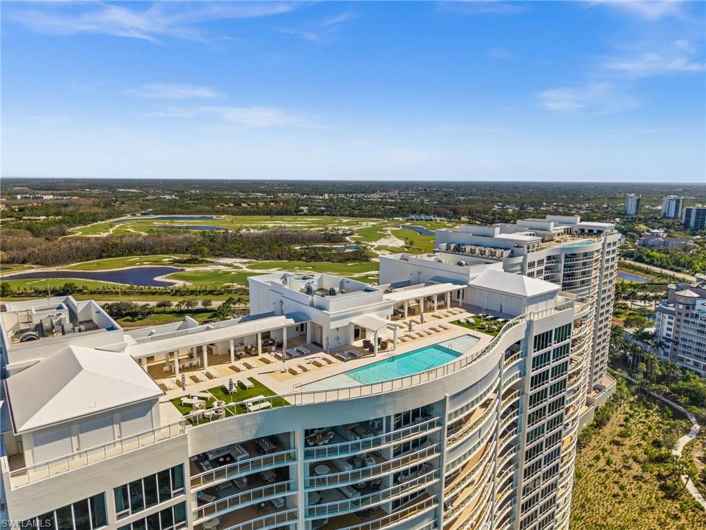 13925 Old Coast Road, Unit 1705 Naples, FL 34110 - Photo 29 of 42 Aerial view of a large body of water and a pool area