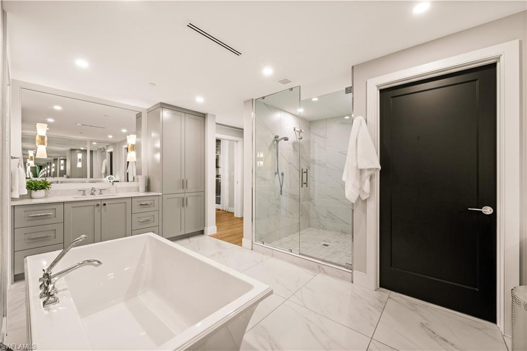 13925 Old Coast Road, Unit 1705 Naples, FL 34110 - Photo 5 of 42 Bathroom featuring a freestanding bath, vanity, a marble finish shower, light marble finish flooring, and recessed lighting