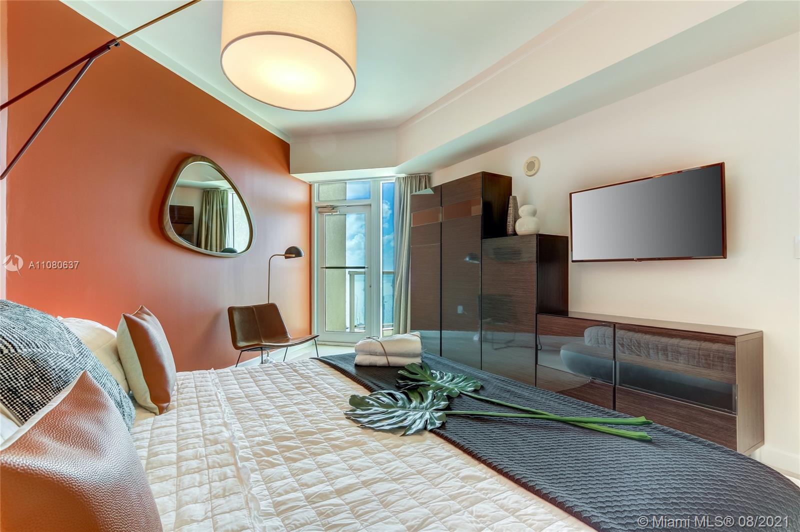 2889 McFarlane Road, Unit 2114 Coconut Grove, FL 33133 - Photo 11 of 15 a living room with furniture and a flat screen tv