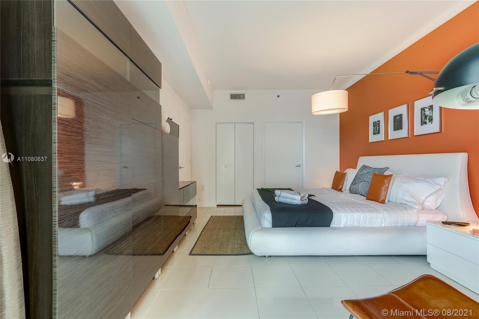 2889 McFarlane Road, Unit 2114 Coconut Grove, FL 33133 - Photo 12 of 15 a living room with furniture and a couch