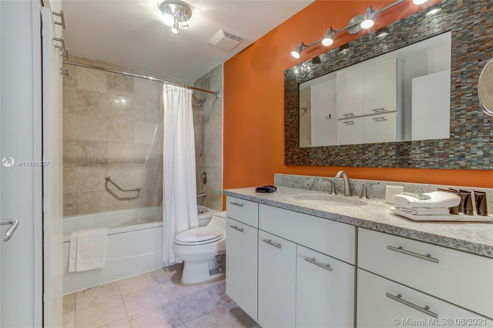 2889 McFarlane Road, Unit 2114 Coconut Grove, FL 33133 - Photo 13 of 15 a bathroom with a granite countertop sink a toilet and shower