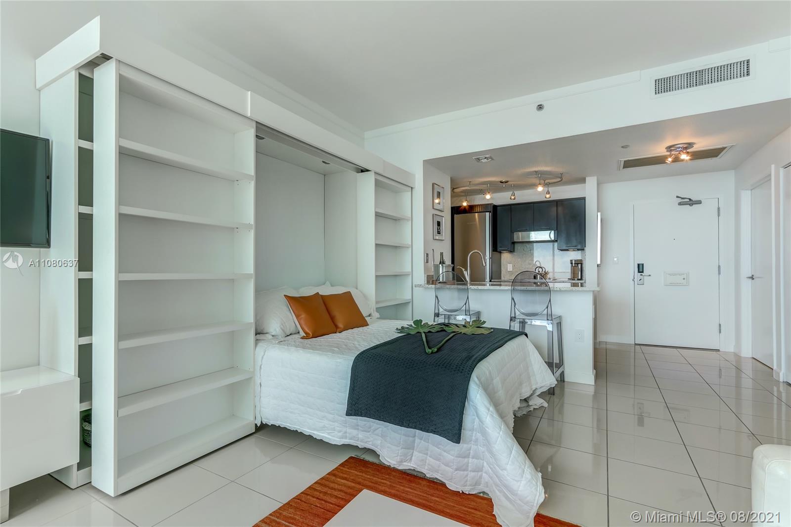 2889 McFarlane Road, Unit 2114 Coconut Grove, FL 33133 - Photo 5 of 15 a bed room with a bed and furniture