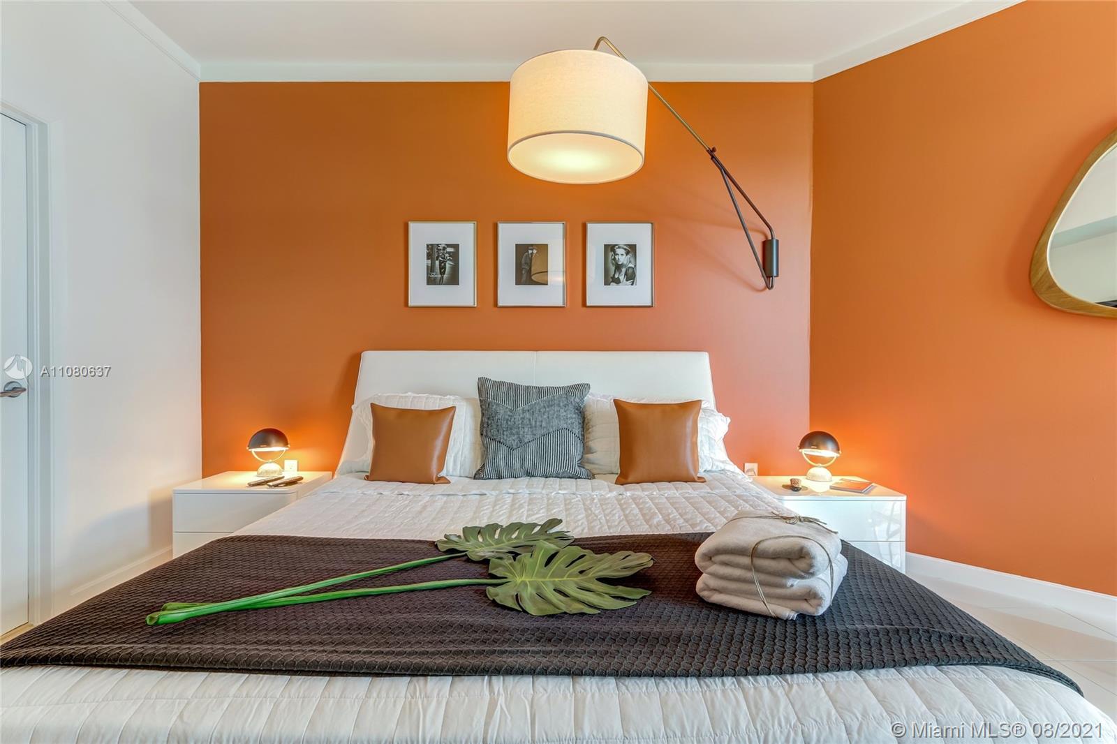 2889 McFarlane Road, Unit 2114 Coconut Grove, FL 33133 - Photo 9 of 15 a bedroom with a bed and wooden floor