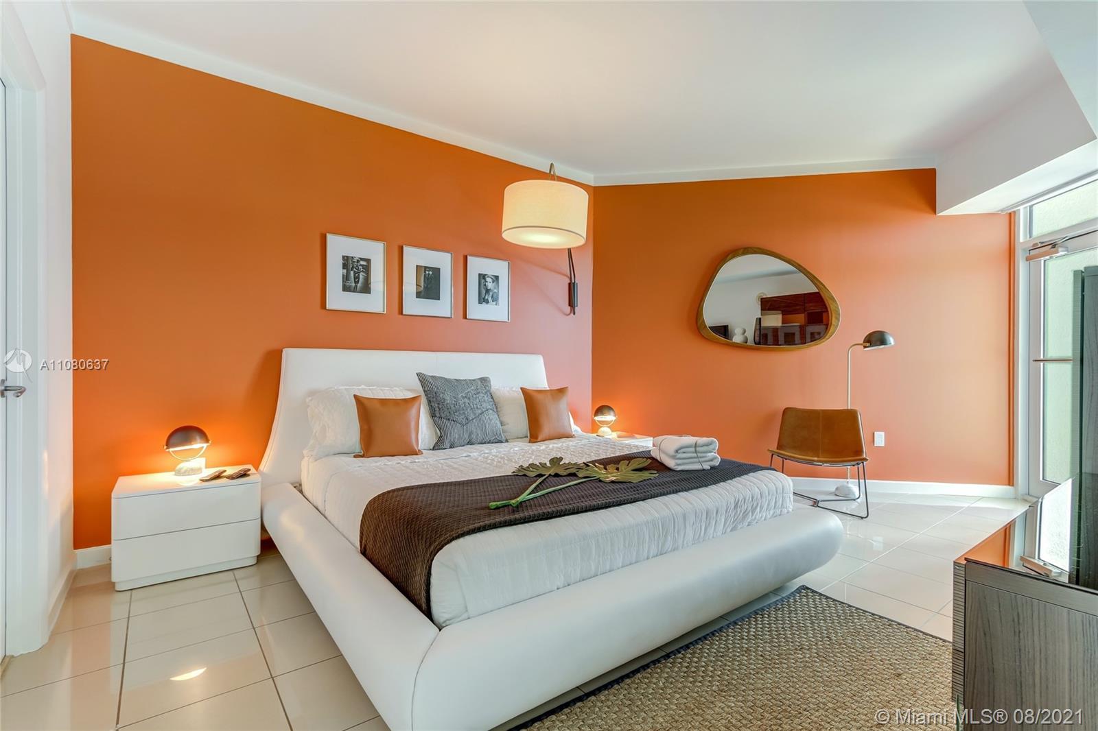 2889 McFarlane Road, Unit 2114 Coconut Grove, FL 33133 - Photo 10 of 15 a bedroom with a bed and lamp