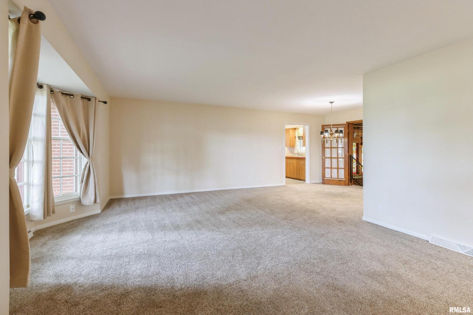 1136 Bobetta Court Clinton, IA 52732 - Photo 6 of 28 a view of an empty room with a window