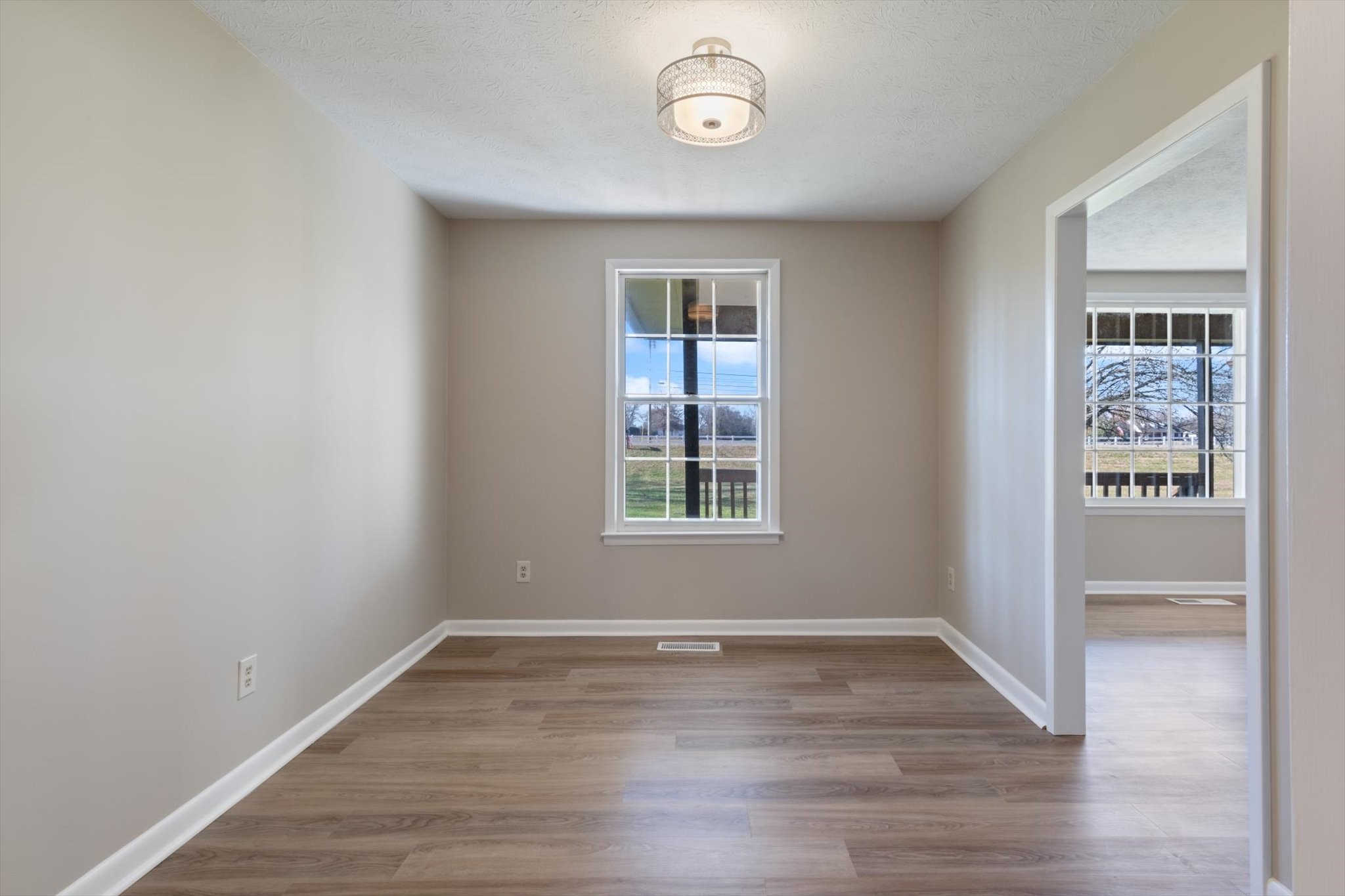 7956 Lebanon Road Murfreesboro, TN 37129 - Photo 13 of 24 wooden floor in an empty room with a window