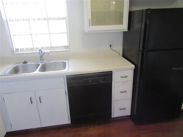 a kitchen with a sink and a refrigerator