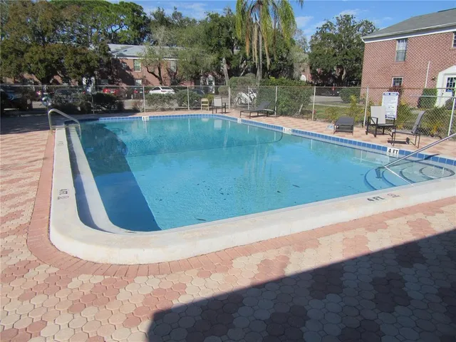 a view of a porch with furniture and floor to ceiling window