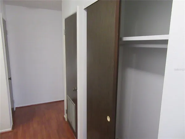 a view of hallway with wooden floor