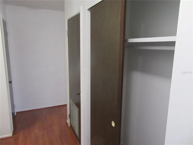 a view of hallway with wooden floor