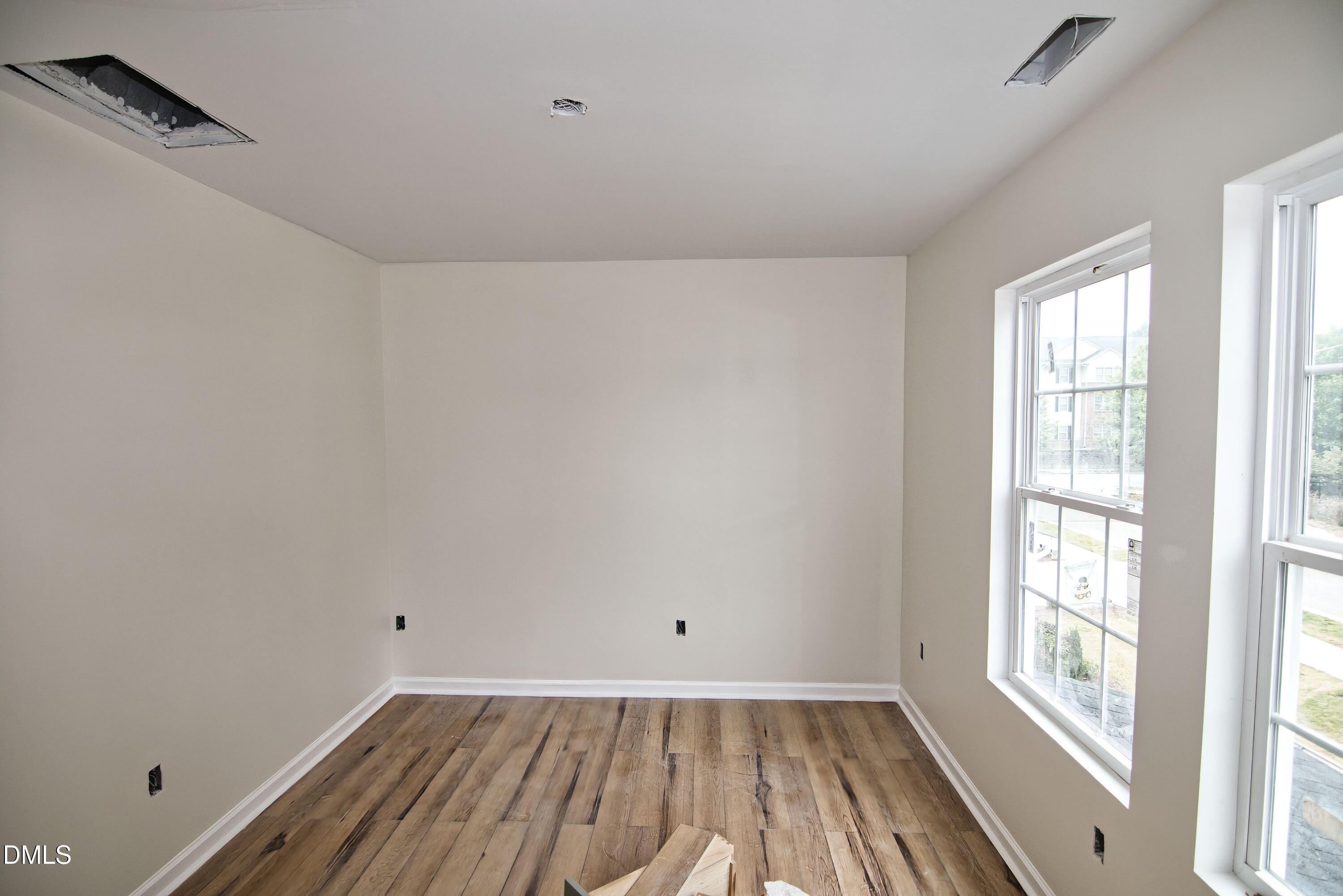 1009 Ridge Rock Road Raleigh, NC 27610 - Photo 4 of 8 wooden floor in an empty room with a window